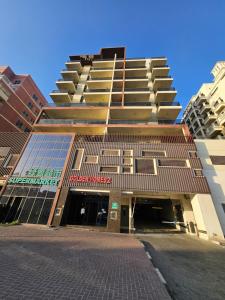 a tall building with a parking garage in front of it at Golden Homes 2 in Dubai