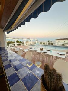 a table with wine glasses sitting on a patio at Villa Cala Lanuza in Alicante