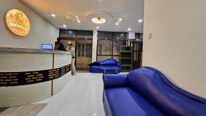 a bar with blue couches in a waiting room at FUNKY MONKEY- A Hostel, Hotel and Apartment in Kathmandu