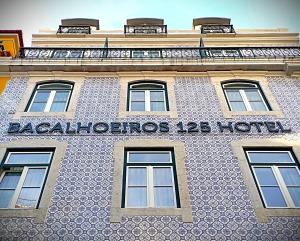 a building with a sign on the side of it at Bacalhoeiros 125 Hotel in Lisbon