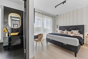a bedroom with a bed and a sink and a mirror at Villa Delecto in Premantura +48 photos