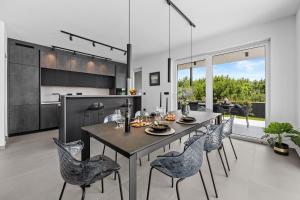 a kitchen and dining room with a table and chairs at Villa Delecto in Premantura