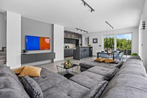a living room with two couches and a tv at Villa Delecto in Premantura