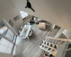 an overhead view of a living room with a table and chairs at LT35a Haus Sternengucker in Dorum-Neufeld