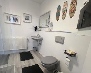 a bathroom with a toilet and a sink at LT35a Haus Sternengucker in Dorum-Neufeld