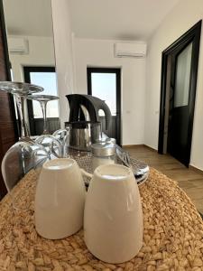 a table with two white dishes on top of it at Ambelas Getaways in Himare +29 photos