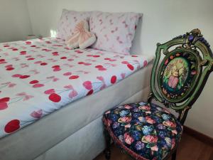 a bedroom with a bed with a chair next to it at Cozy Zdrój in Lądek-Zdrój +5 photos