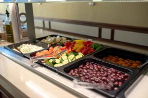 a buffet with many trays of fruits and vegetables at Depandance Vodoléčba in Lázně Libverda