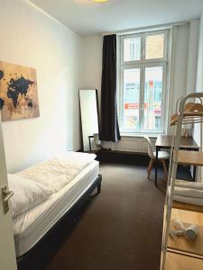 a bedroom with a bed and a window and a ladder at Hotel Colonnaden by O&N in Hamburg