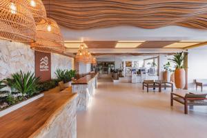 a lobby of a restaurant with benches and tables at Rio Quente Resorts Refúgio Grand Premium - Antigo Hotel Turismo in Rio Quente +101 photos