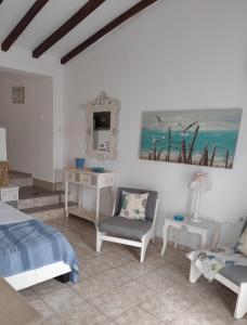 a bedroom with a bed and a chair and a table at Alexia Studios in Kolios