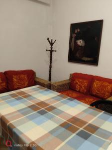a room with a bed and a couch and a picture at Nonna Maria Bed and Breakfast in Caserta