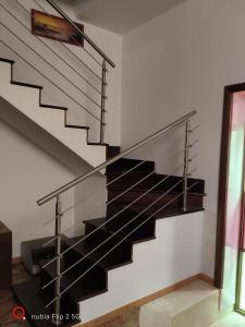 a staircase in a house with black metal railings at Nonna Maria Bed and Breakfast in Caserta