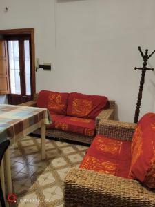 a living room with a red couch and a table at Nonna Maria Bed and Breakfast in Caserta