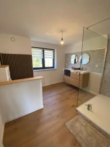 a bathroom with a glass shower and a sink at La maison d'à côté - Sart in Jalhay +18 photos
