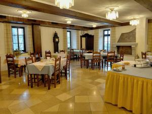 a dining room with tables and chairs and a fireplace at Rohrbacher Hof in Berg bei Rohrbach