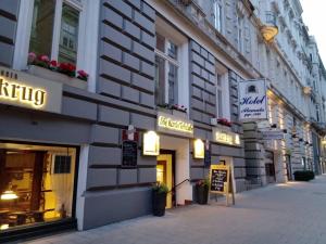 a building with signs on the side of a street at Hotel Colonnaden by O&N in Hamburg