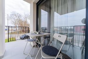 a balcony with a table and two chairs at Flex SelfCheckIns 99 - 2 Bedrooms - Parking - Loggia in Velika Mlaka
