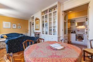 a living room with a table and a couch at Casa Orta appartamento con vista lago in Orta San Giulio