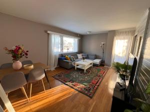 a living room with a couch and a table at Stylish 2-bedrooms apartment, smart TV, Netflix, parking - Oslo in Oslo