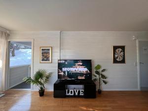 a living room with a flat screen tv on a wall at Stylish 2-bedrooms apartment, smart TV, Netflix, parking - Oslo in Oslo