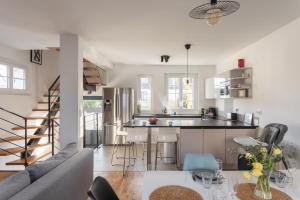 a kitchen and living room with a couch and a table at P'ty Solidor - 500m du port in Saint Malo +8 photos