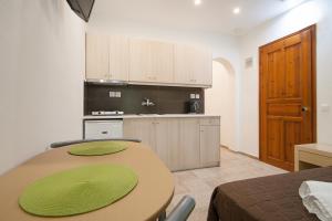 a kitchen with a wooden table and a kitchen with a counter at Villa ALEXIS in Koukounaries