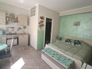 a small bedroom with a bed and a kitchen at La Rosa Verde in Castrovillari +23 photos