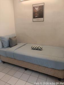 a bed in a room with a picture on the wall at Olio CoLiving Pudu Kuala Lumpur in Kuala Lumpur +7 photos