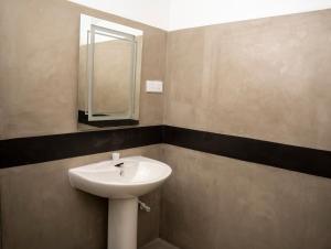 a bathroom with a sink and a mirror at Nagalakanda Eco Lodge in Millewa
