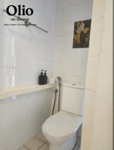a bathroom with a white toilet in a room at Olio CoLiving Pudu Kuala Lumpur in Kuala Lumpur