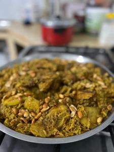 a pan filled with food on top of a stove at The Martian Bubbles - Wadi Rum in Wadi Rum