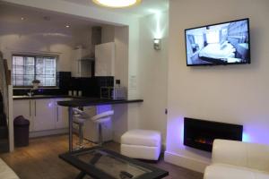 a living room with a tv hanging on the wall at Yarm View Guest House and Cottages in Yarm