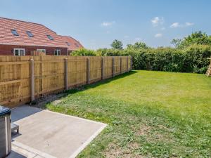 a wooden fence in a backyard with a yard at Dawson Park 8 - Uk12667 in Mablethorpe
