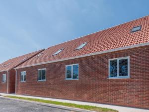 a red brick building with a red roof at Dawson Park 8 - Uk12667 in Mablethorpe