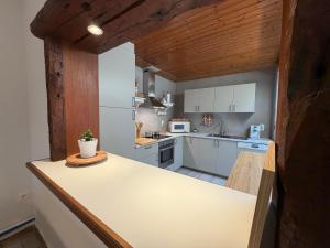 a kitchen with white cabinets and a counter top at Schorrebloem in Lombardsijde