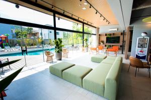 a living room with a couch and a pool at Liwe Hotels in Penha
