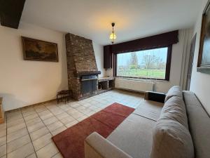 a living room with a couch and a fireplace at Schorrebloem in Lombardsijde