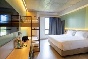 a hotel room with a bed and bunk beds at Liwe Hotels in Penha +101 photos