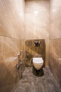 a bathroom with a white toilet in a stall at Hotel American inn in Nakodar +15 photos
