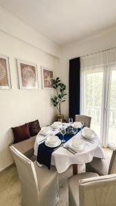 a dining room table with a white table cloth on it at Blue Pearl Molos in Mólos +9 photos