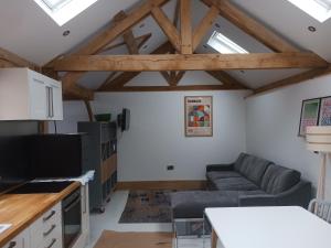 a living room with a couch and a table at Oak framed appartment in Chester