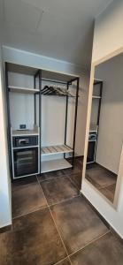 a walk in closet with shelves and a tiled floor at Hotel V7 in Milan