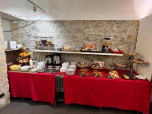 a buffet of food on two tables with red table cloth at Hotel Tonic in Palermo