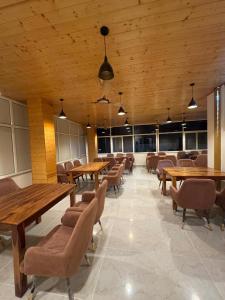 a dining room with wooden tables and chairs at Hotel Blue Moon in Rishīkesh