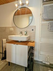 a bathroom with a sink and a mirror at Gemütliches, helles, voll ausgestattetes Apartment mit Terrasse in Waal +20 photos