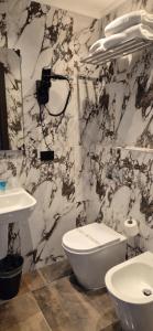 a bathroom with a white toilet and a sink at Hotel V7 in Milan