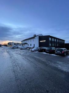 a parking lot with cars parked next to a building at Rygge Apartments in Moss