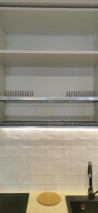 a kitchen with a sink and a long shelf at Airport Friendly Studio in Bydgoszcz
