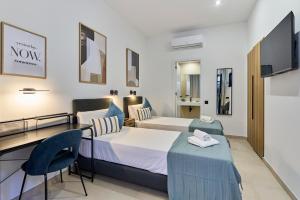 a hotel room with a bed and a desk at Sant Adrià Urban Suites by gaiarooms in Badalona +66 photos